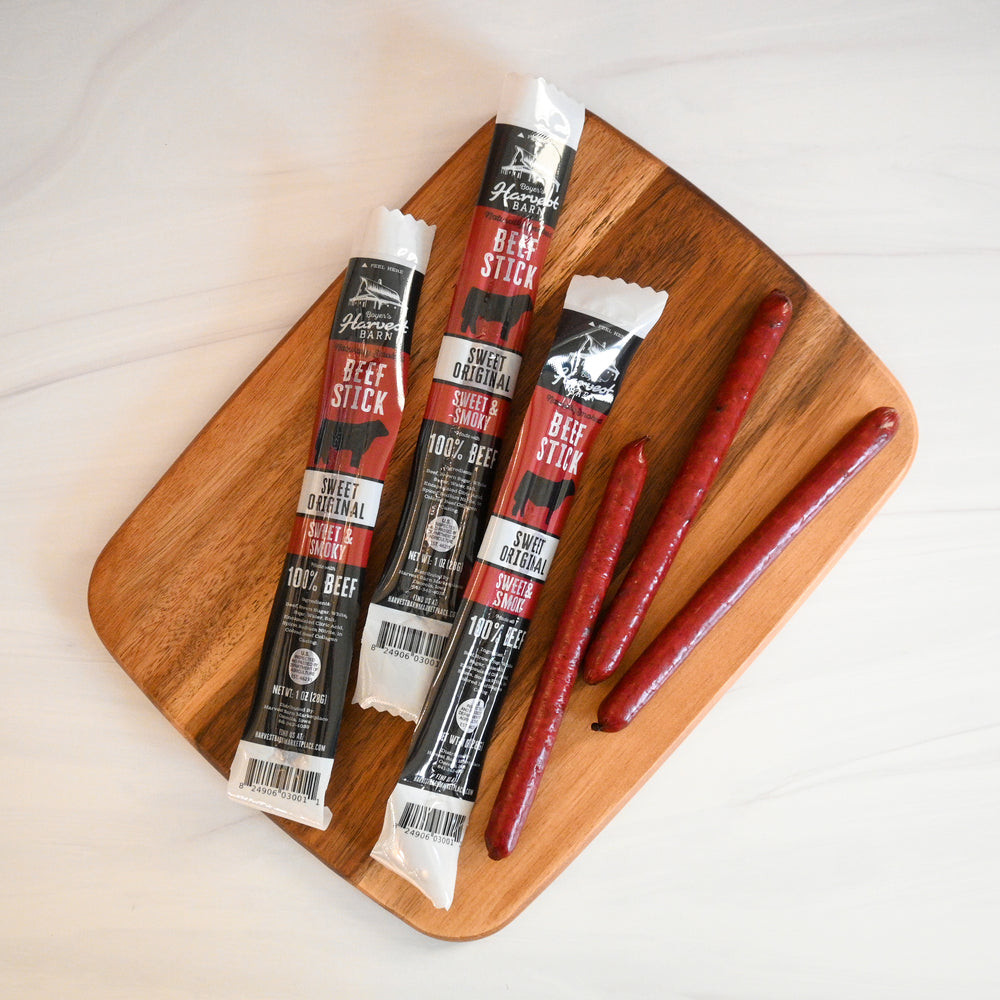 original beef sticks in and out of packaging on a cutting board